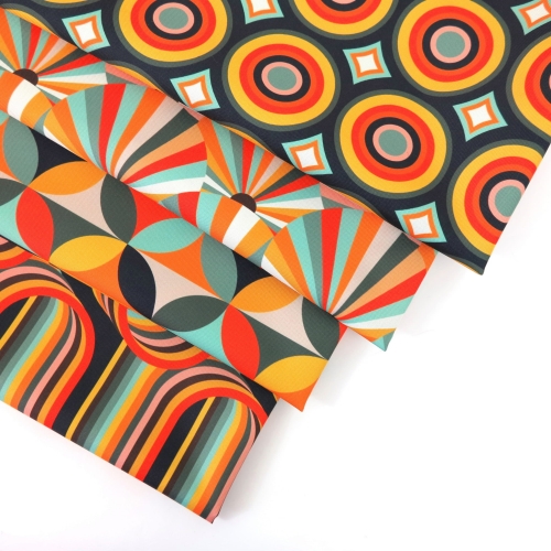 TKANINA WODOODPORNA Kółka retro pomarańczowe na grafitowym